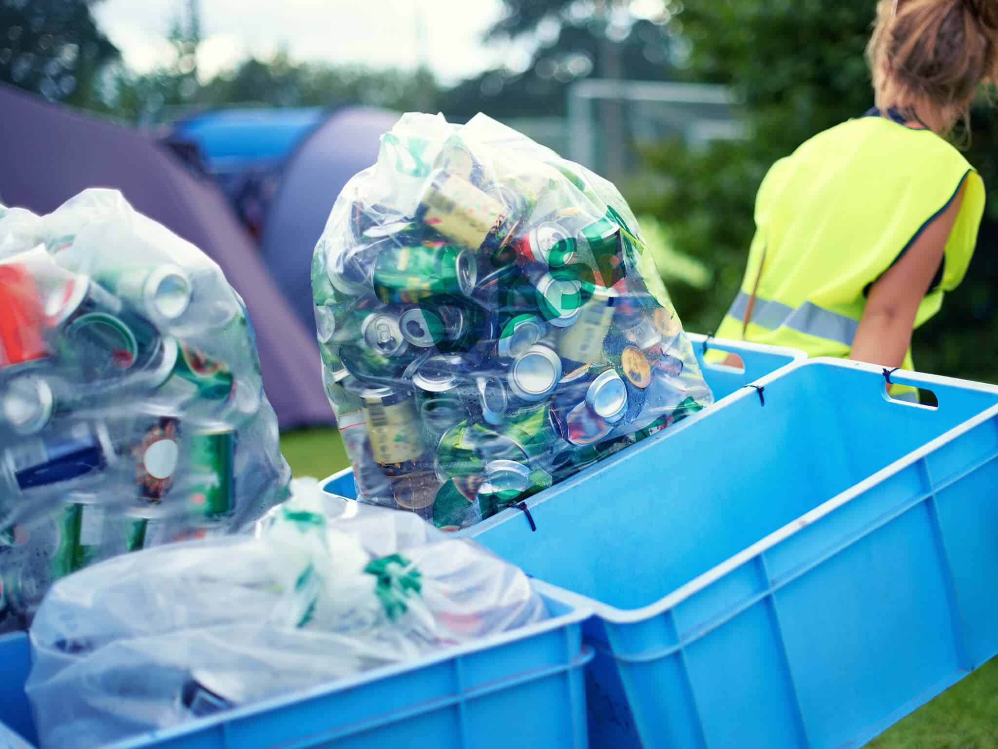 Cleaning up the aftermath of the festival. two young women picking up trash after a festival.